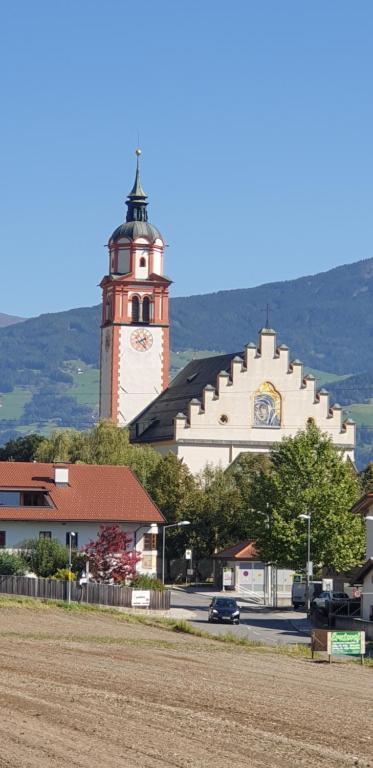un gran edificio con una torre de reloj encima en Ferienwohnung Heidi en Absam