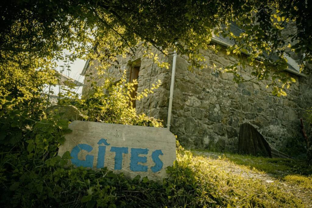 a stone building with a sign that says a cities at Les Gîtes du Gouélou in Callac