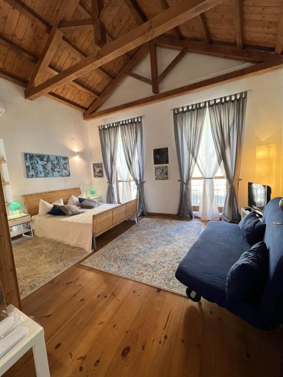 a large living room with two beds and windows at Studio Apartments Centro Storico Via Manno in Cagliari