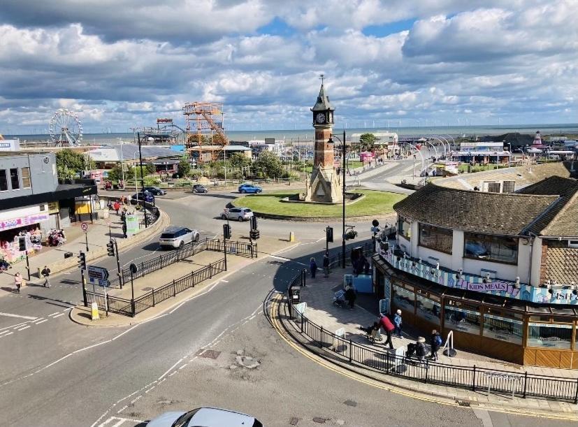 a town with a clock tower in the middle of a street at Marine Boathouse View Apartment in Skegness