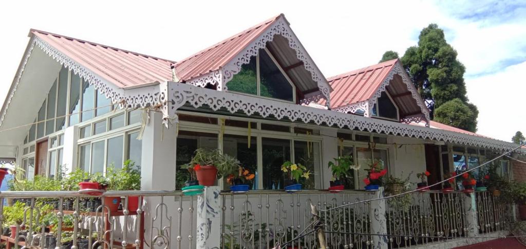 a house with a fence in front of it at RISE N SHINE HOMESTAY in Darjeeling