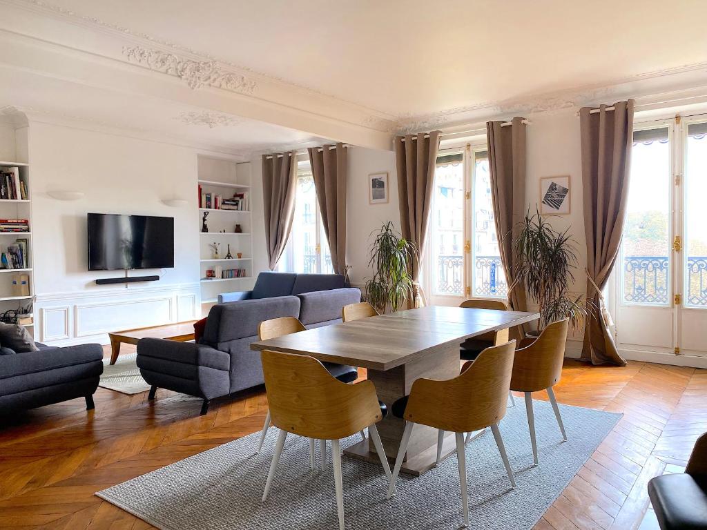 a living room with a table and chairs at Marvellous Sunbathed 3BR at the heart of Paris in Paris