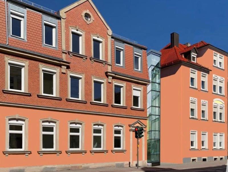 a large brick building on the corner of a street at EASTSIDE Living - Wohnen auf Zeit - KRAL Hotels Erlangen in Erlangen