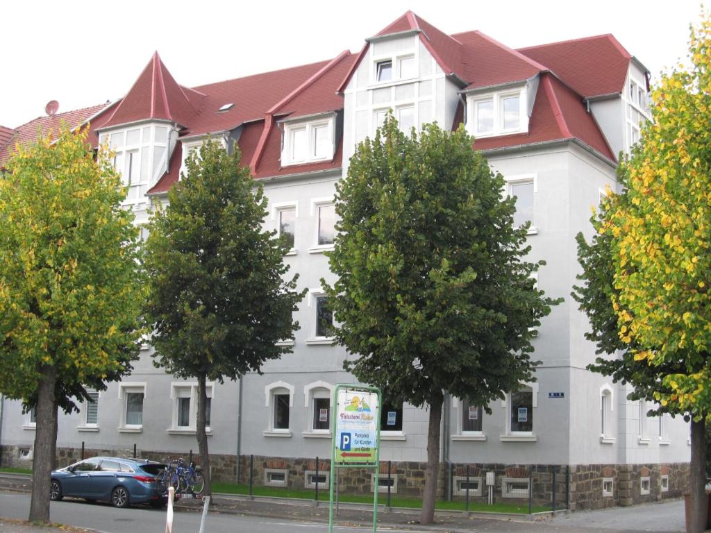 ein großes weißes Gebäude mit rotem Dach in der Unterkunft Appartment Ipsum in Löbau