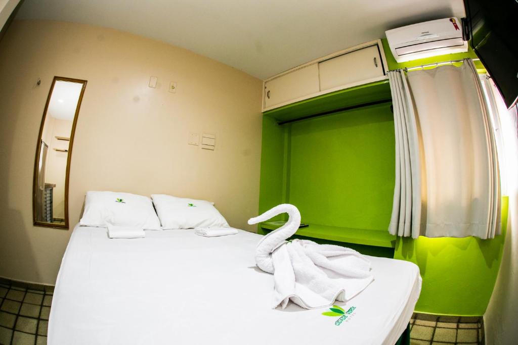 A bed or beds in a room at Cidade Verde Flat Hotel