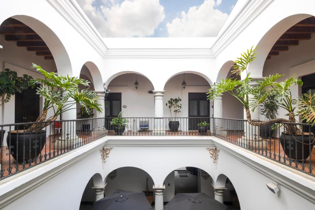 a view of therium of a building with potted plants at Hotel Boutique Naura Centro in Oaxaca City