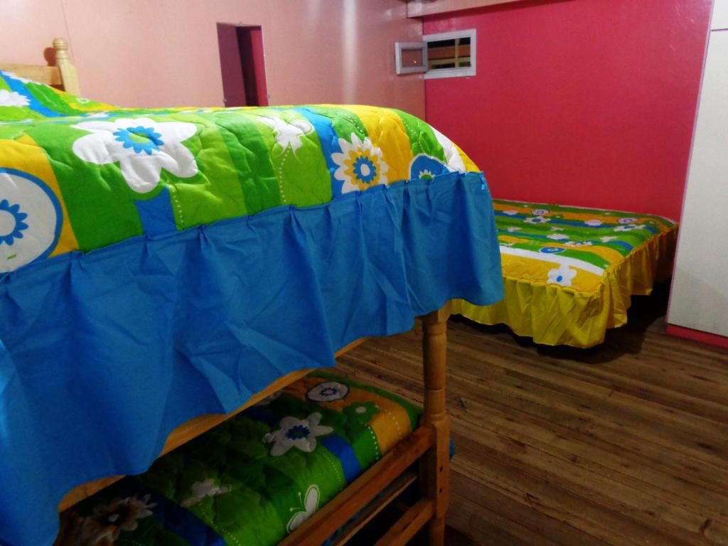 Postel nebo postele na pokoji v ubytování Hostal Yumbo Imperial