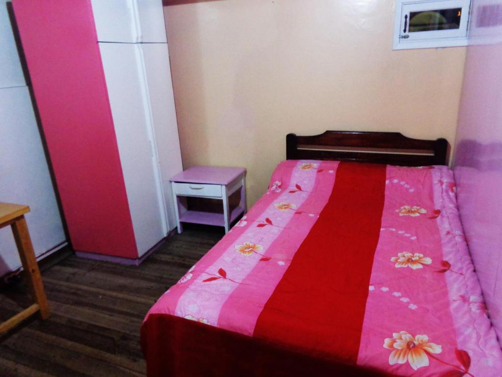 Postel nebo postele na pokoji v ubytování Hostal Yumbo Imperial