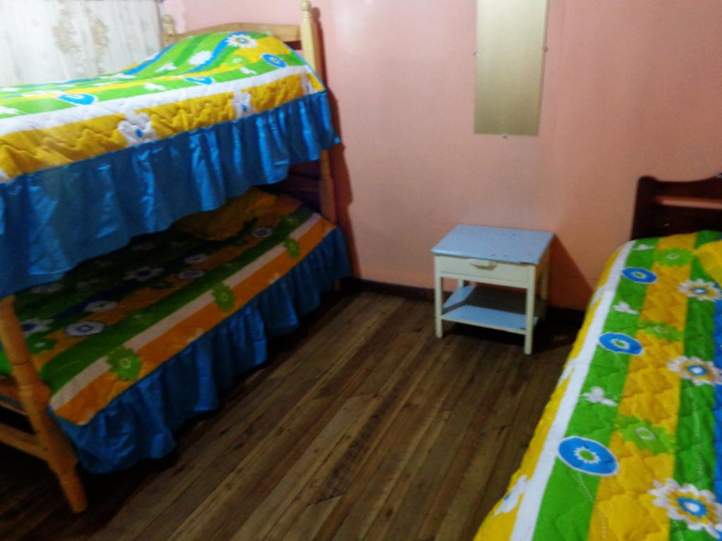 Postel nebo postele na pokoji v ubytování Hostal Yumbo Imperial