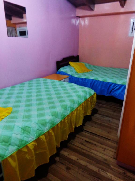 Postel nebo postele na pokoji v ubytování Hostal Yumbo Imperial
