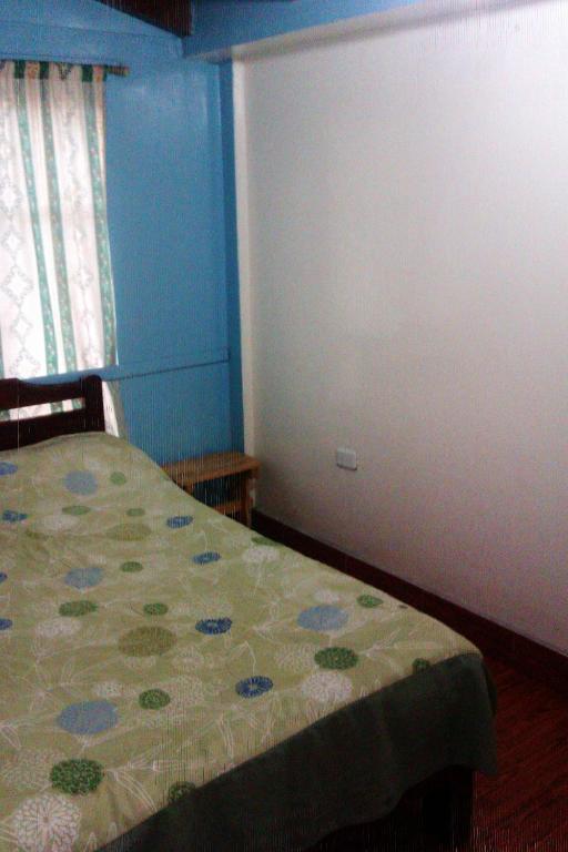 Postel nebo postele na pokoji v ubytování Hostal Yumbo Imperial