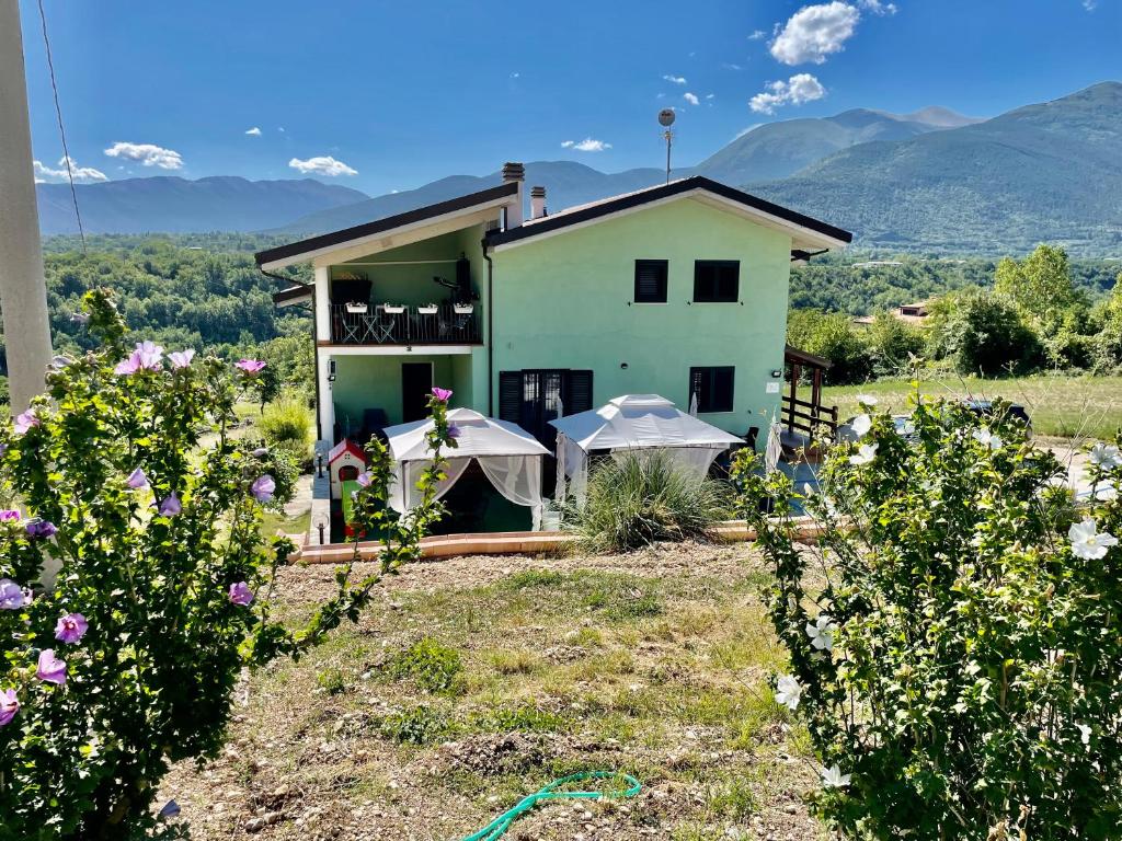 a house on a hill with flowers in front of it at B&b Villa Asia in Sulmona