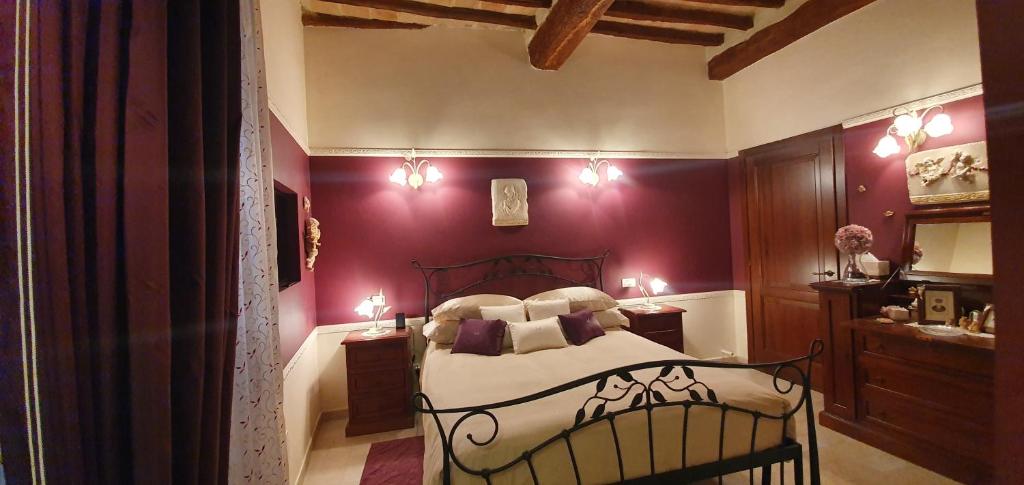 a bedroom with a bed with purple walls at B&B SERENA in Perugia