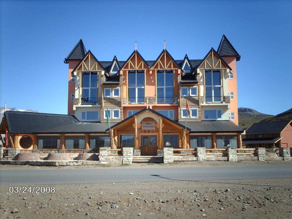 a large house on the side of a road at Hotel Arquimedes in Caviahue