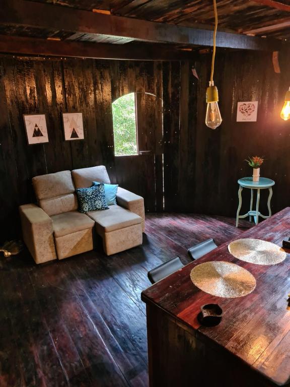 a living room with a couch and a table at Pipa Malbec in Petrópolis