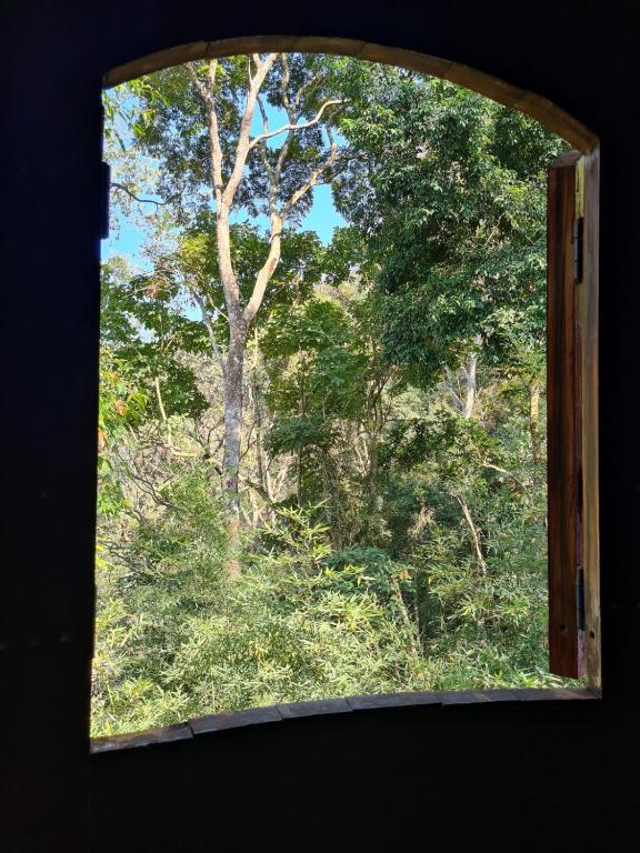 an open window with a view of a forest at Pipa Malbec in Petrópolis