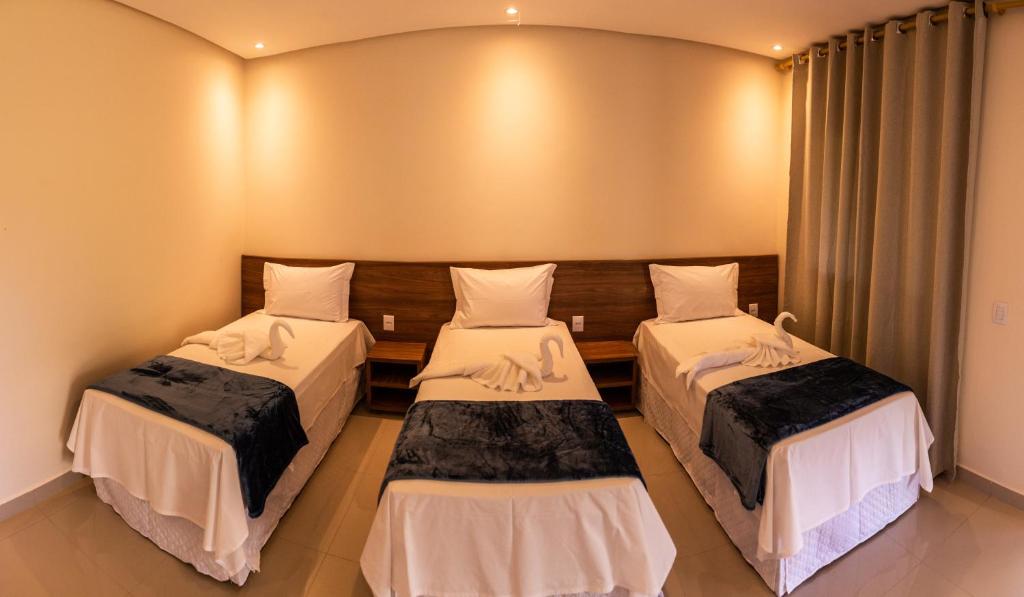En eller flere senge i et værelse på Vila da Mata Chalés