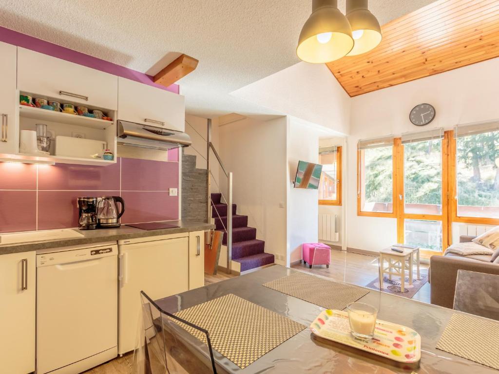 a kitchen and living room with a table and a couch at Appartement La Plagne-Tarentaise, 2 pièces, 5 personnes - FR-1-353-114 in La Plagne Tarentaise