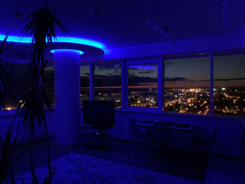 a room with a view of a city at night at 25-th Floor Sea View Apartment in Klaipėda