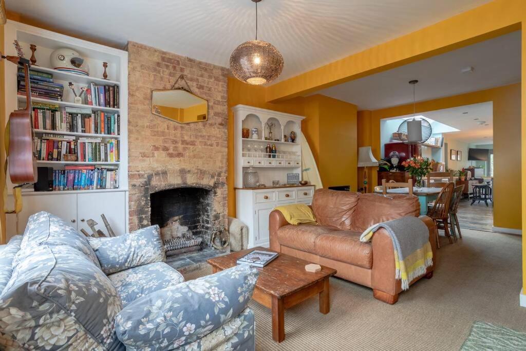 a living room with a couch and a fireplace at Lovely Central Cambridge Home in Cambridge