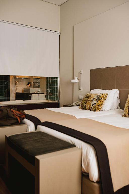 Cama ou camas em um quarto em M'AR De AR Aqueduto