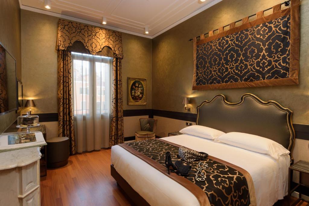 Postel nebo postele na pokoji v ubytování UNAHOTELS Ala Venezia-Adults 16