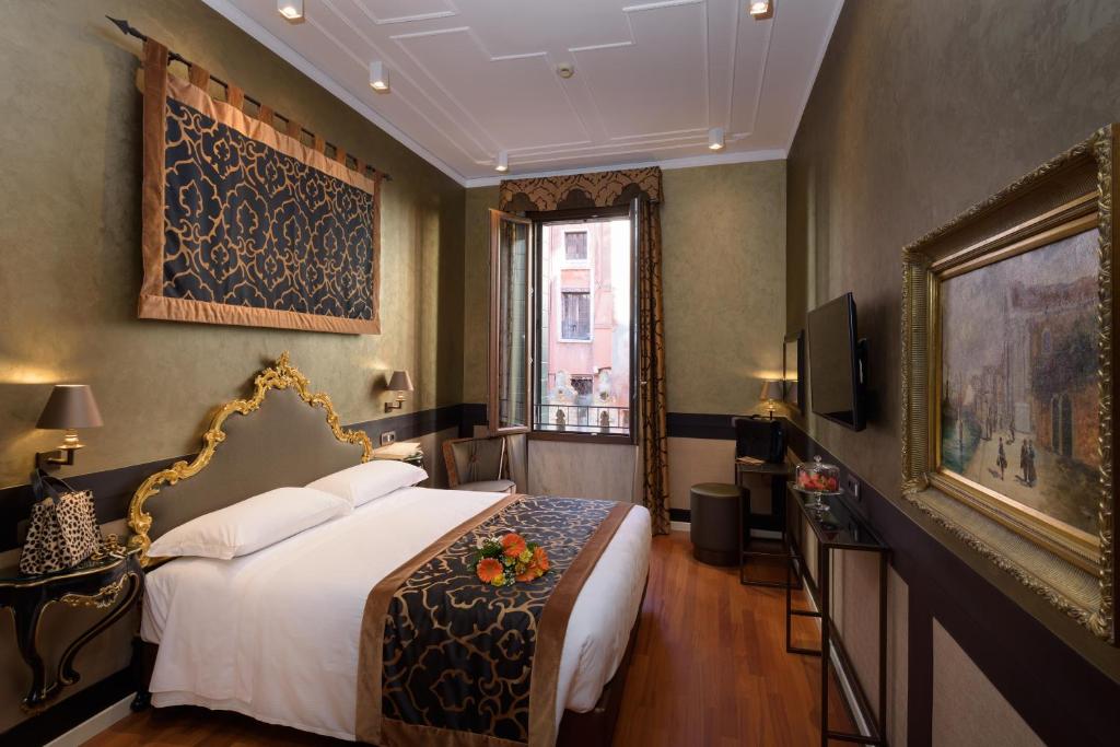 Postel nebo postele na pokoji v ubytování UNAHOTELS Ala Venezia-Adults 16