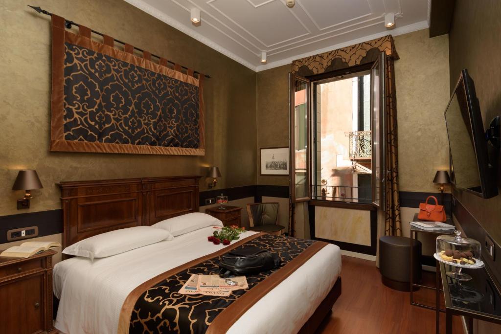 Postel nebo postele na pokoji v ubytování UNAHOTELS Ala Venezia-Adults 16