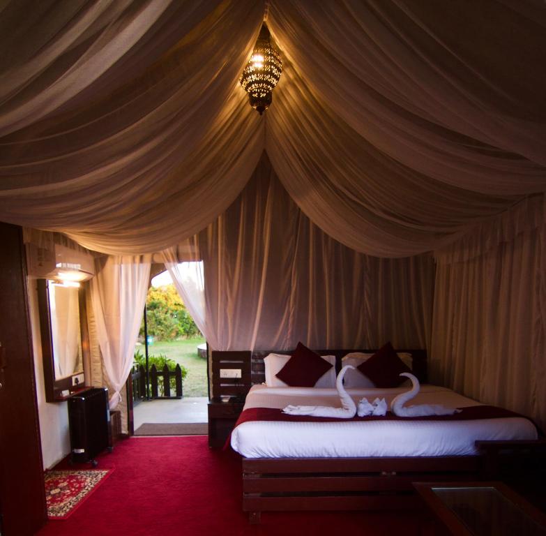 a bedroom with two beds in a tent at Samskara & Samsara in Lansdowne