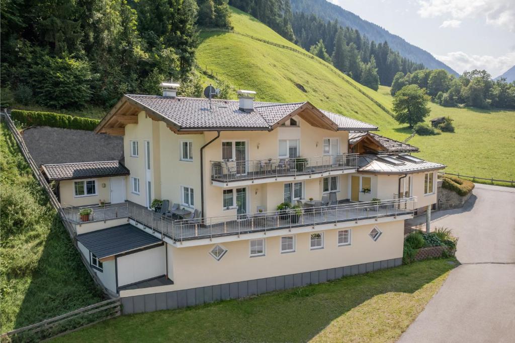 a house on a hill with a mountain at Apartments Nadine in Neustift im Stubaital