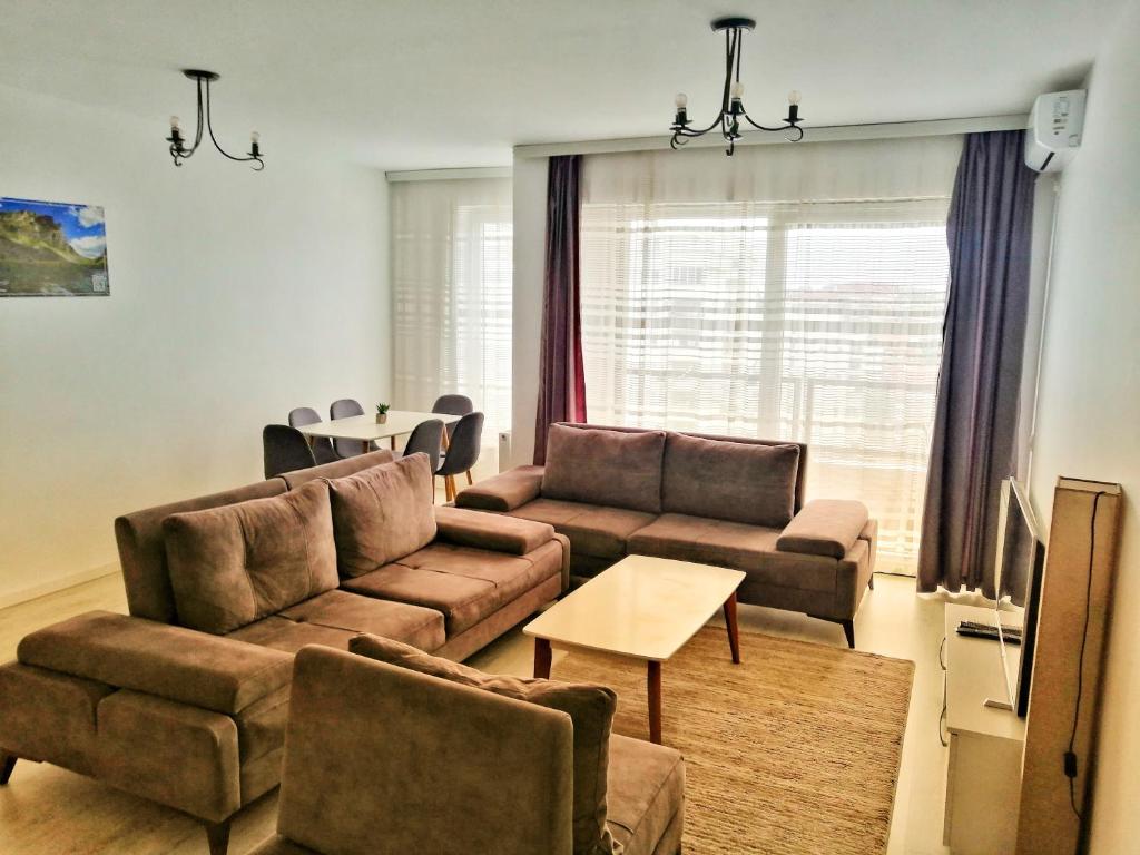 a living room with a couch and a table at Sunflower Apartments in Pristina