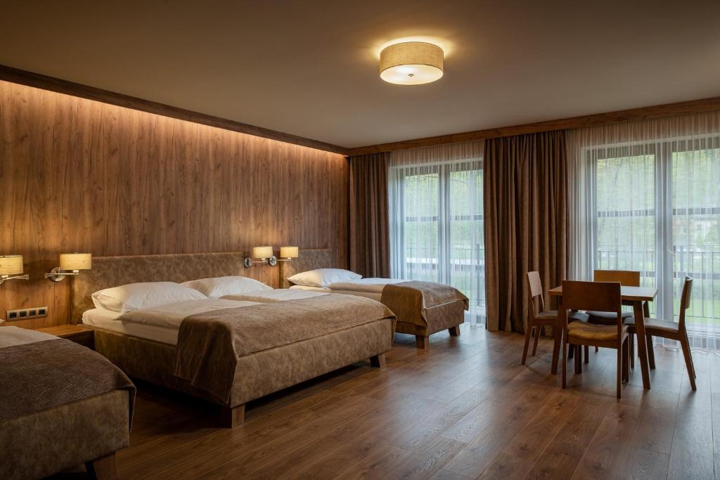 Postel nebo postele na pokoji v ubytování Resort Sobotín