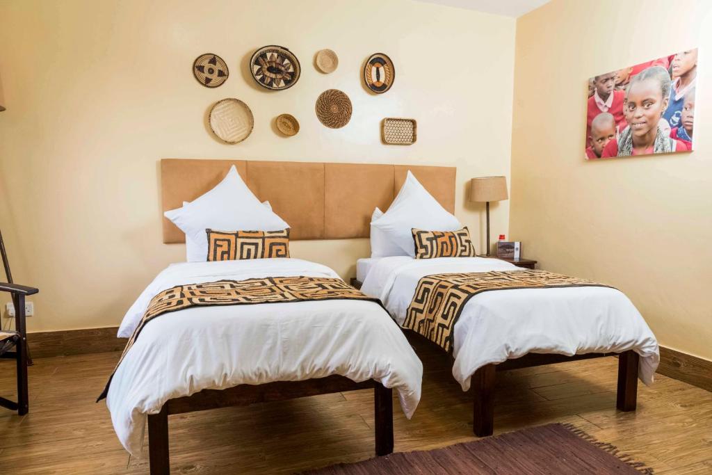 Postel nebo postele na pokoji v ubytování Acacia Tree Lodge