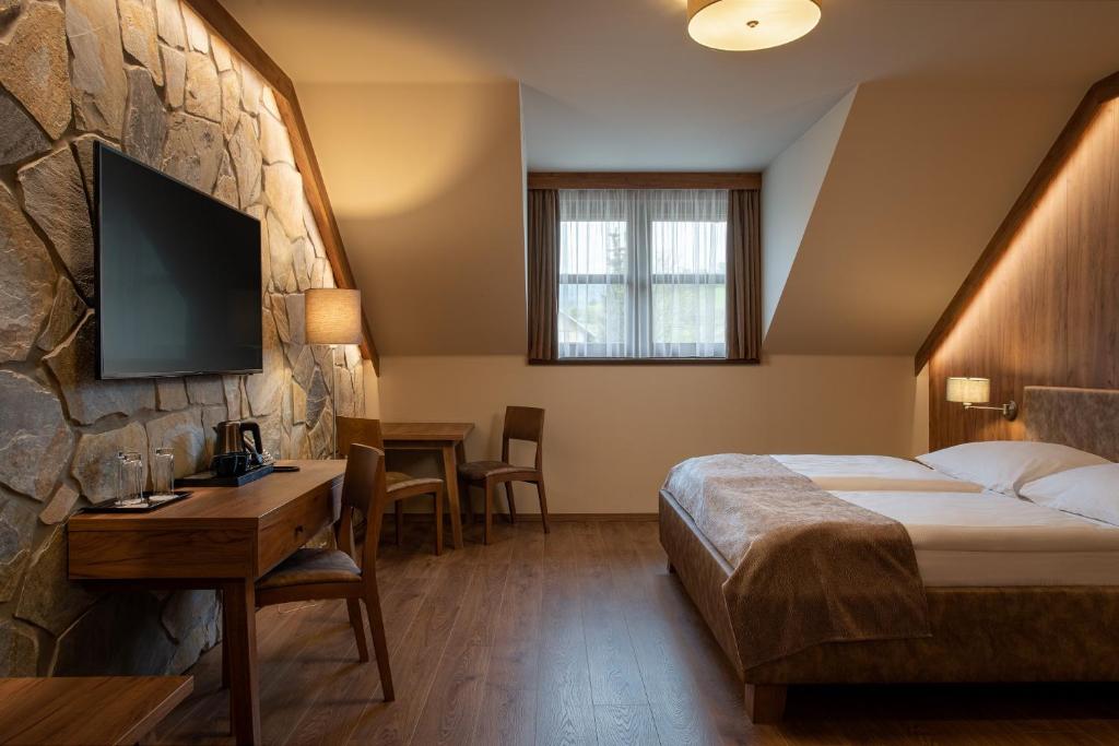 Postel nebo postele na pokoji v ubytování Resort Sobotín