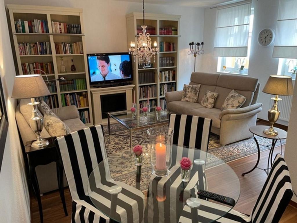 a living room with a table and chairs and a couch at Apartment Stadthaus Perleberg in Perleberg