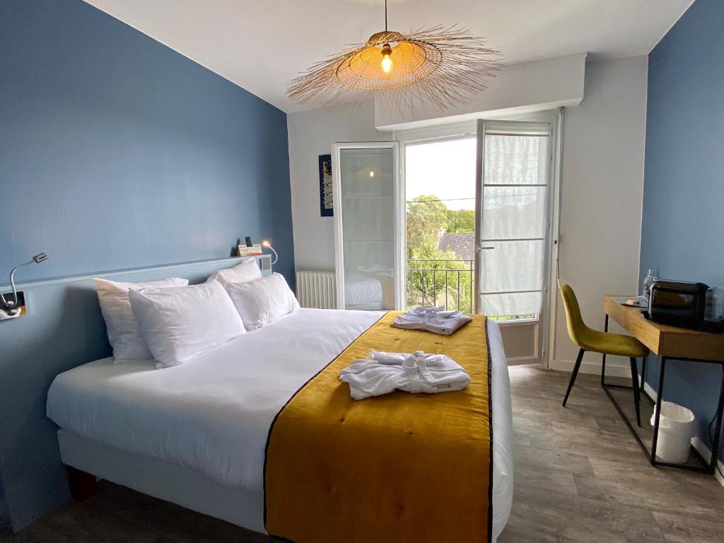 a bedroom with a bed with a desk and a window at Maison des Dunes in Erdeven