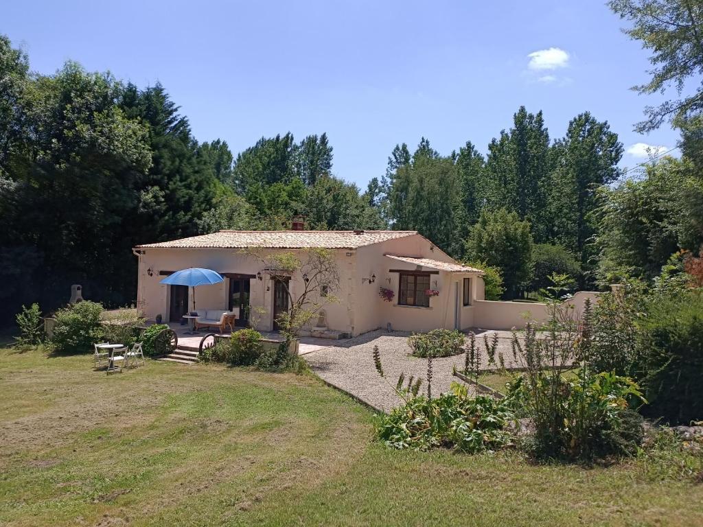 a small house in a field with a yard at Mas des Maje in Boisredon