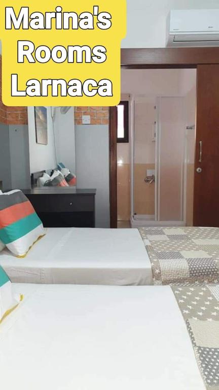Кровать или кровати в номере Marina's Rooms