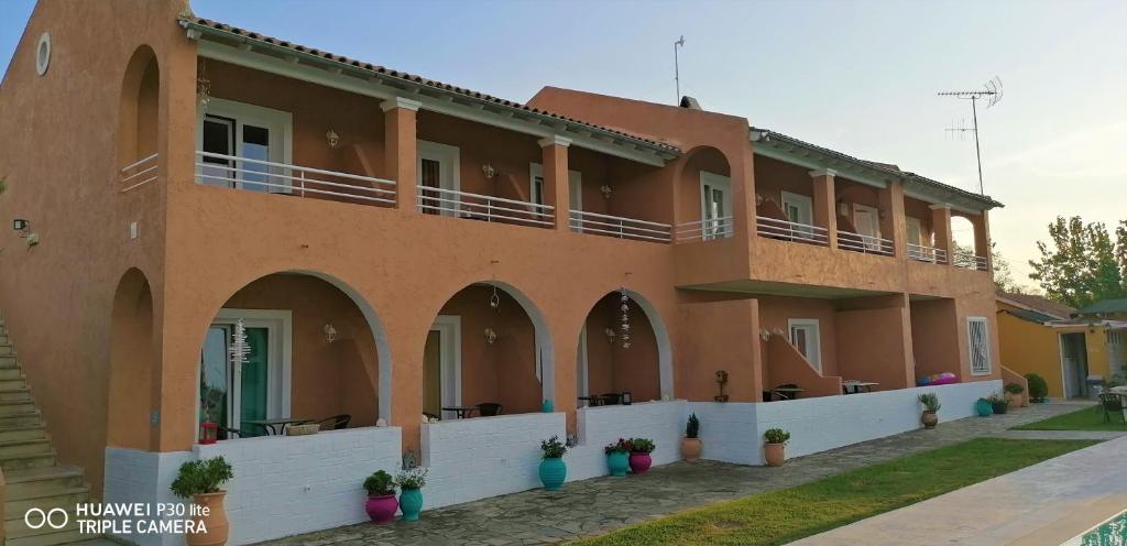 a large building with balconies on the side of it at Sausan Hotel in Sidari