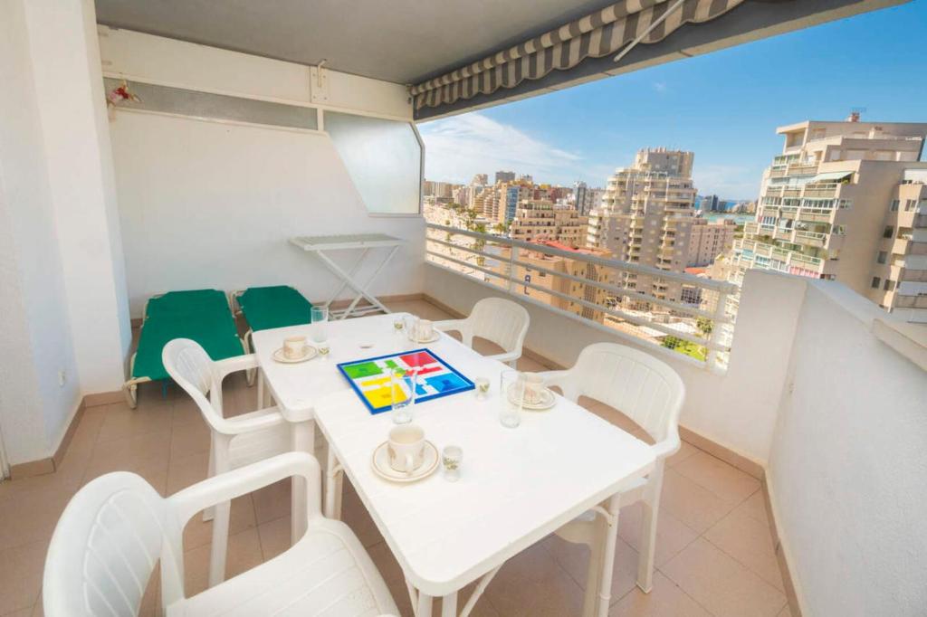 a white table and chairs in a room with a window at Esmeralda 311a in Calpe