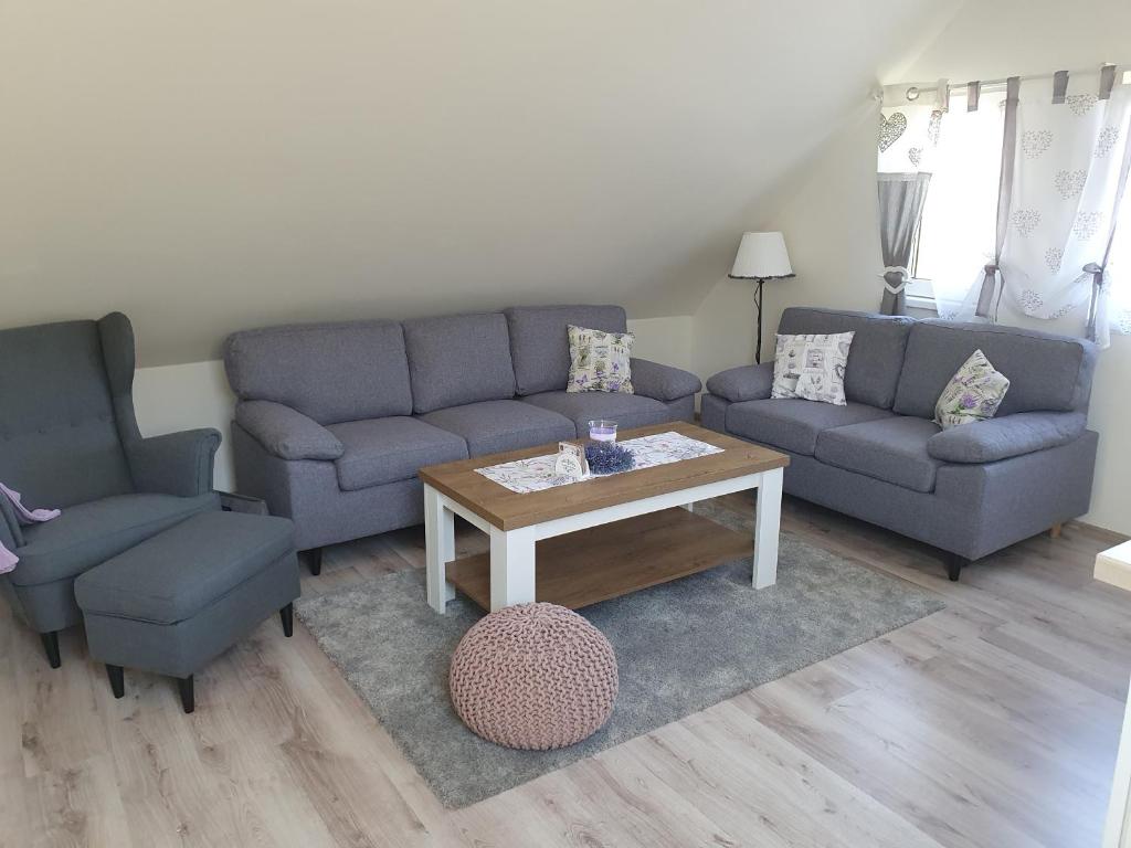 a living room with two couches and a coffee table at Apartmán Bobo in Stožok
