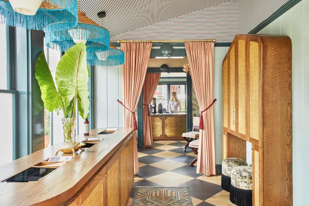 a salon with a long counter with chairs and plants at Faraway Nantucket in Nantucket