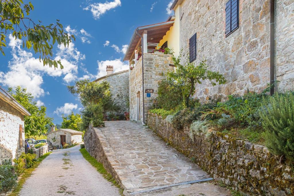 a stone alleyway in front of a building at Rooms Nela in Hum