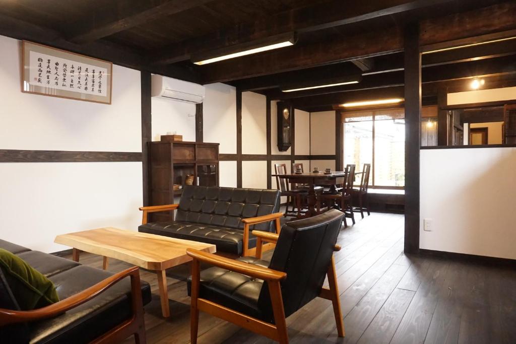 a room with couches and a table and chairs at Jisaburo Ozawa's residence - Vacation STAY 66110v in Saito