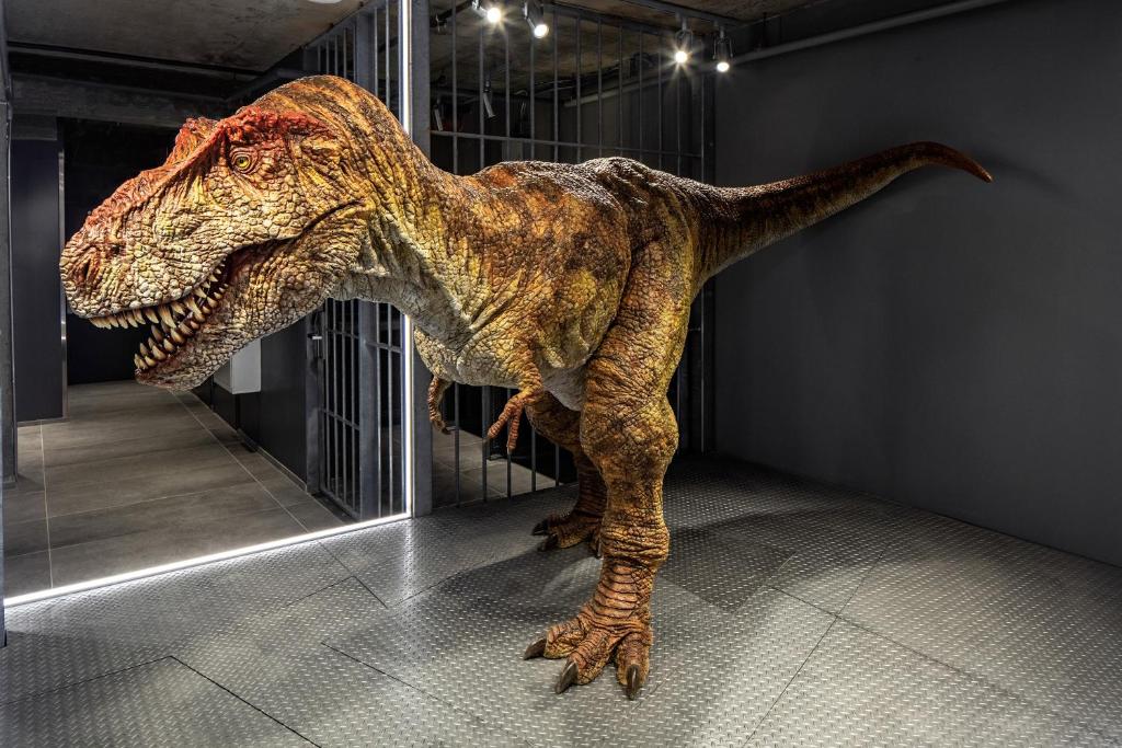 a dinosaur statue is standing in a room at Henn na Hotel New York in New York