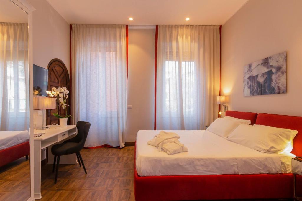a hotel room with a bed and a desk and a room at Hotel Villa Alberti Portofino Land in Santa Margherita Ligure
