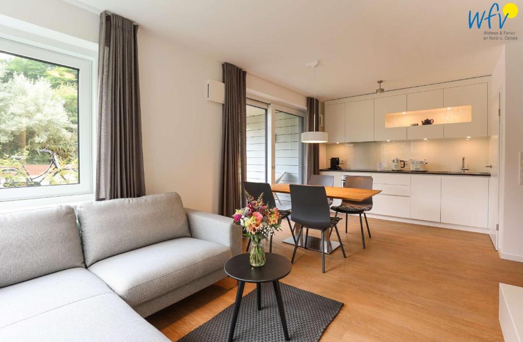 a living room with a couch and a table at Haus Talita - Wohnung BRAVO in Juist