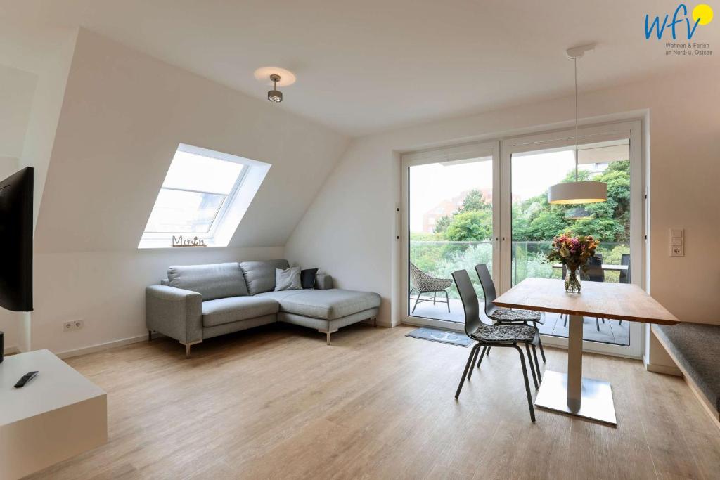 a living room with a couch and a table at Haus Talita - Wohnung ZULU in Juist