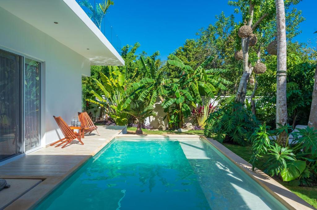a swimming pool in the backyard of a house at Villa Calma, Chic & Mexican Villa, a True Oasis Pool, Security in Tulum