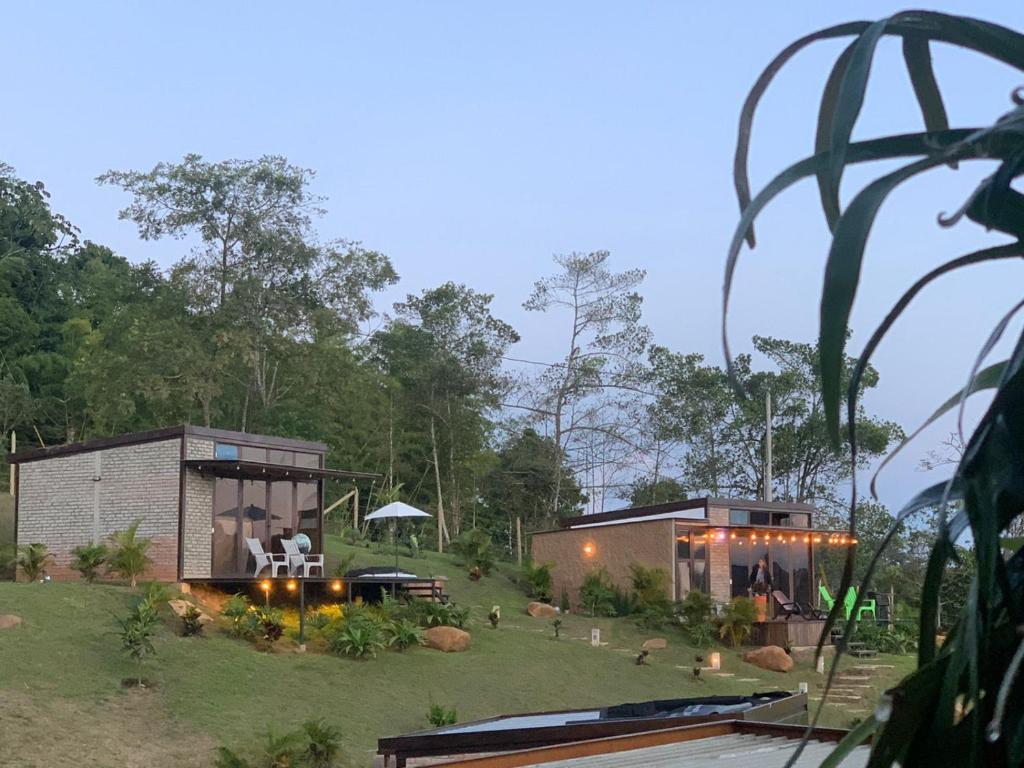 a house in the middle of a yard at ADAMA BIOHOTEL in Calima